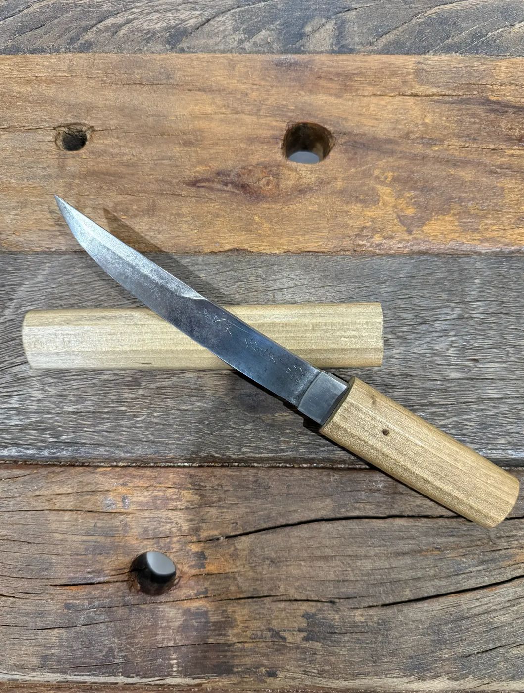 The blade and its plain wooden scabbard.