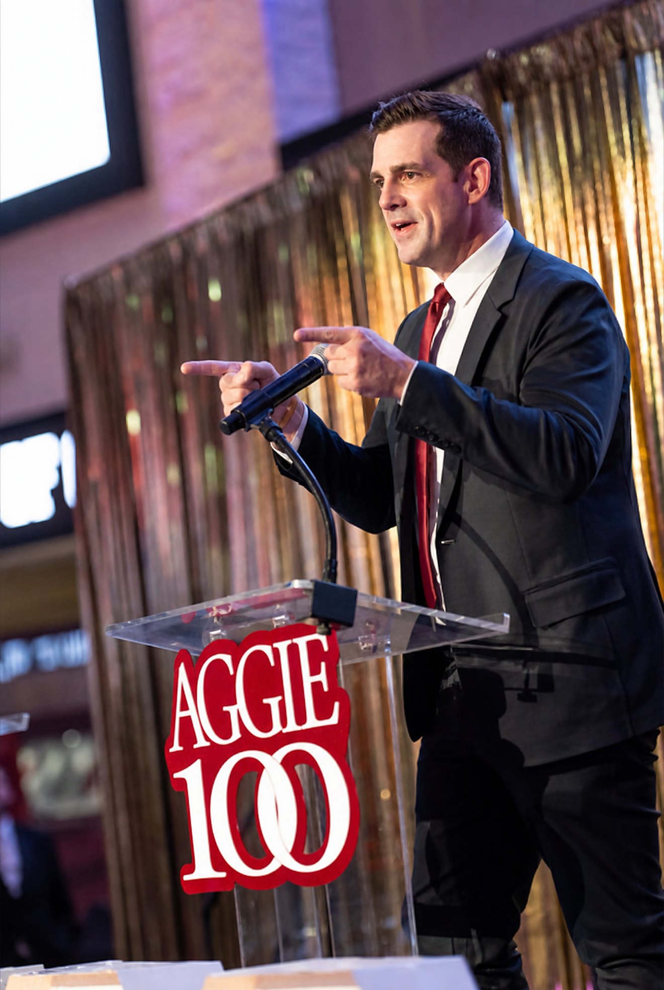 Chris Valletta speaking at the Aggie 100 podium