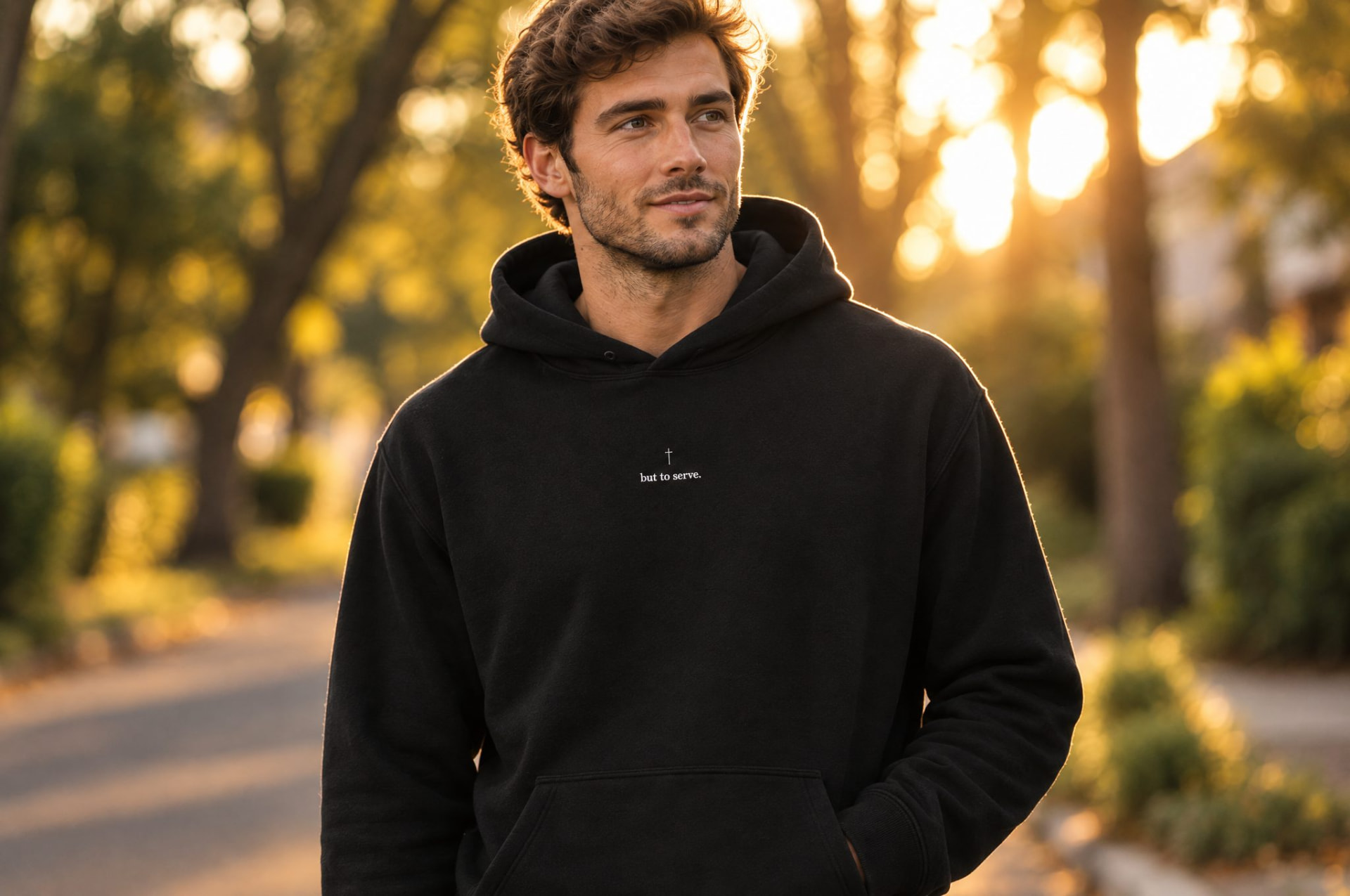 Man wearing the black But to Serve embroidered hoodie